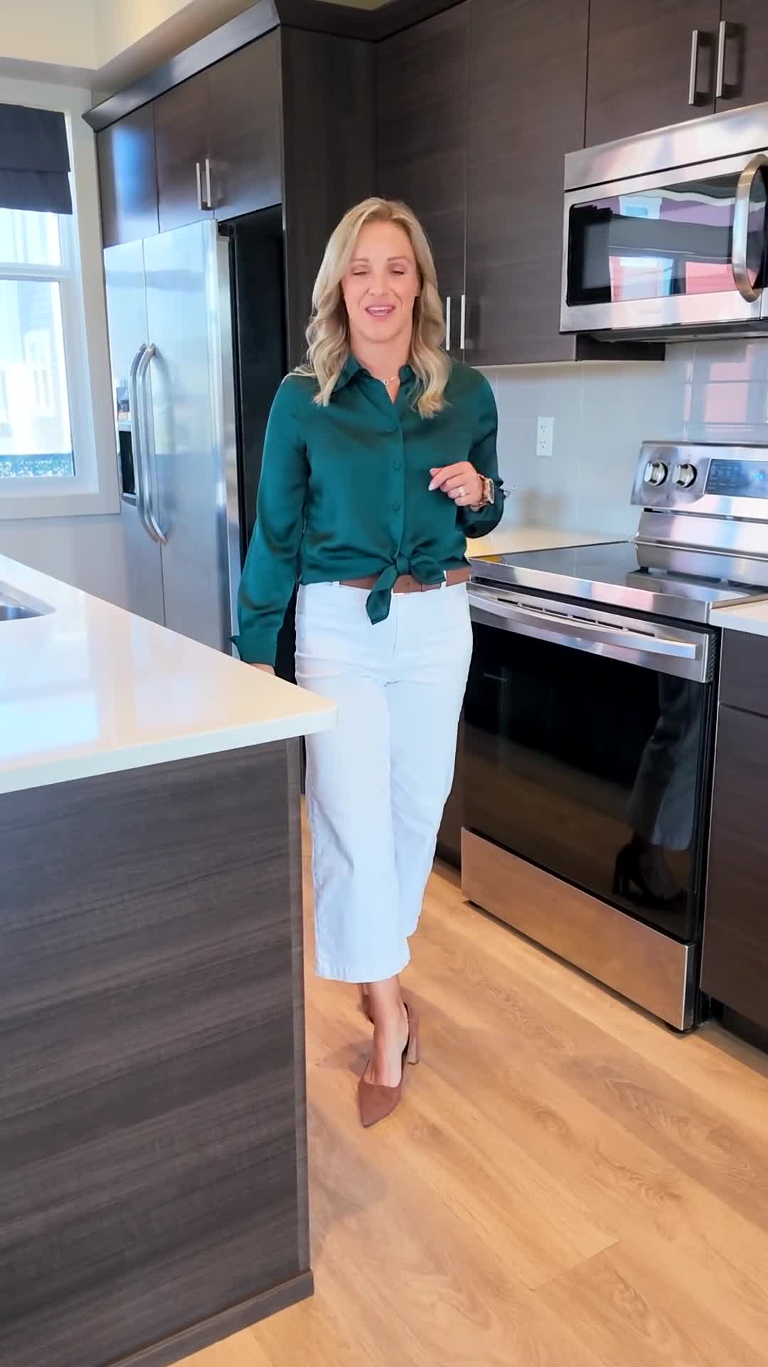 Realtor presenting a property on camera in a kitchen