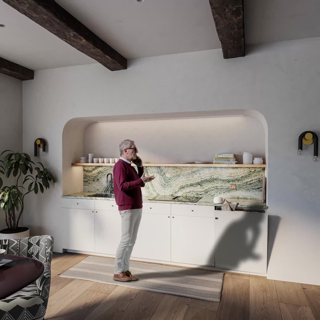 Still from a Loma Visual animation: a person in a kitchen with natural stone and exposed timber beams.