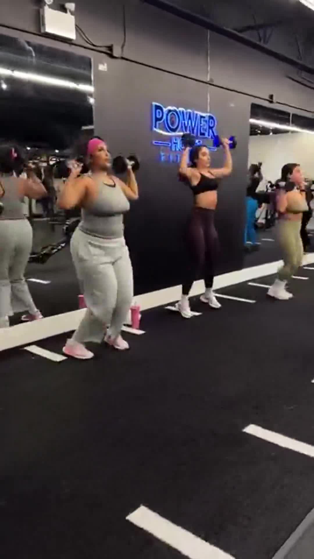 Women training with dumbbells in a mixed Power House class