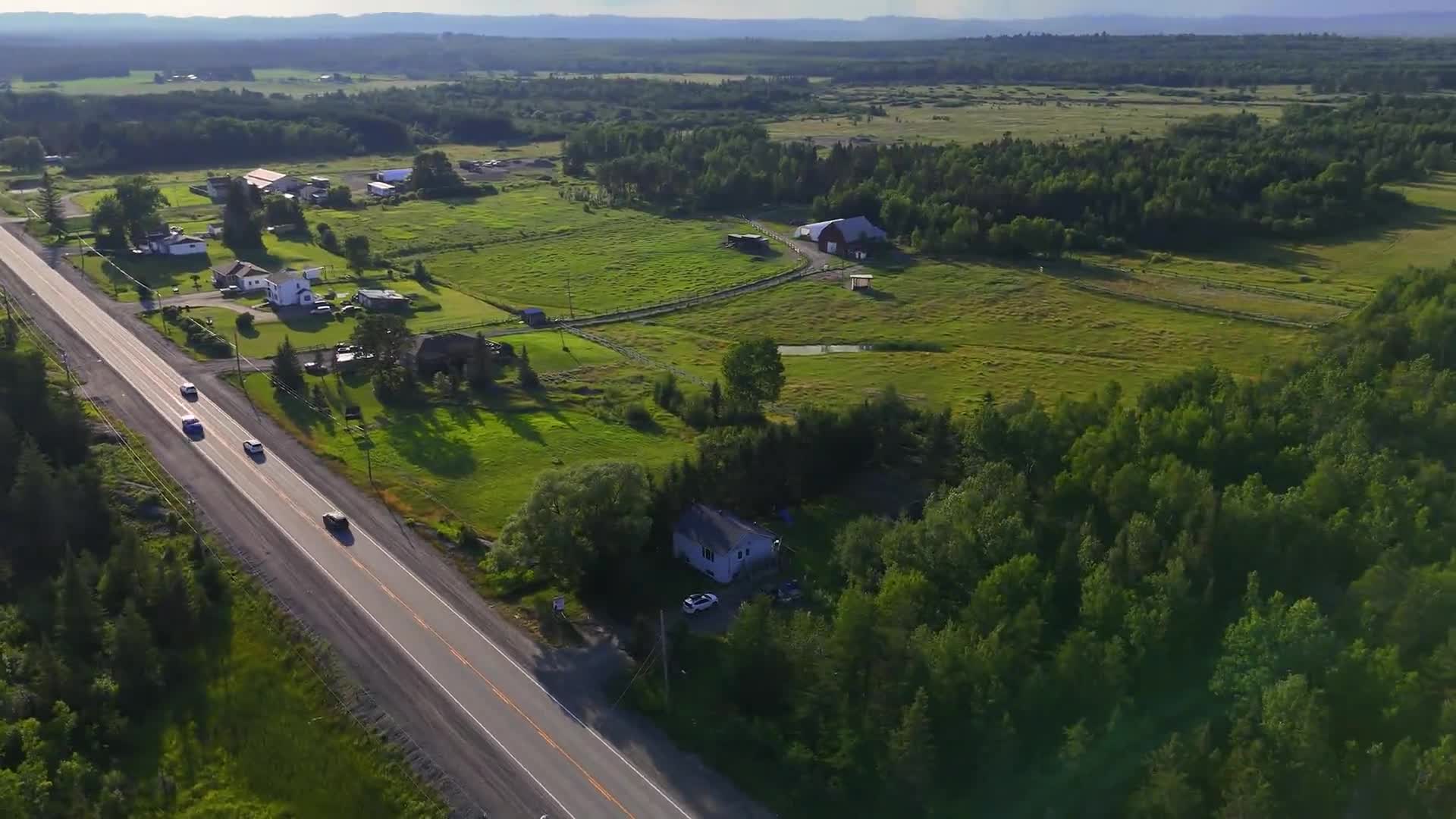 Aerial view of fields, homes, and a rural road from Remind Media’s videography portfolio
