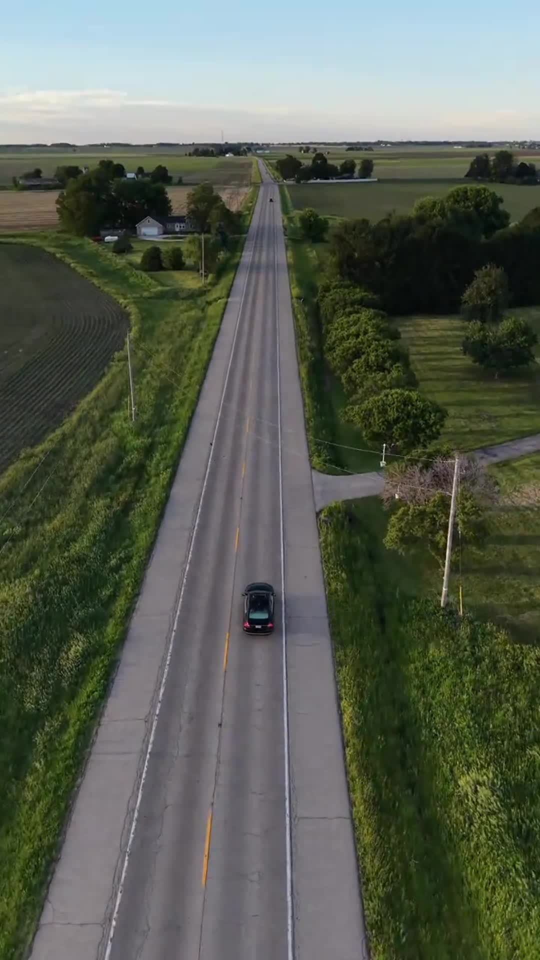 Aerial top-down frame of a car on a rural central Illinois highway