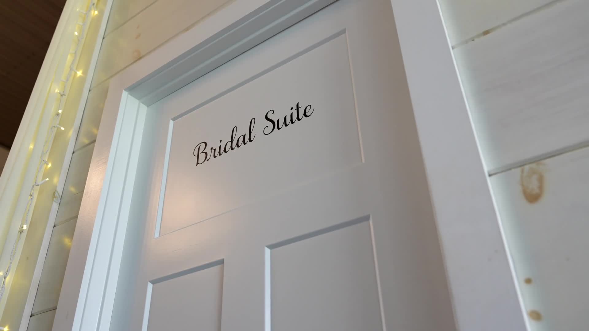 A bridal suite door at the start of a wedding film.