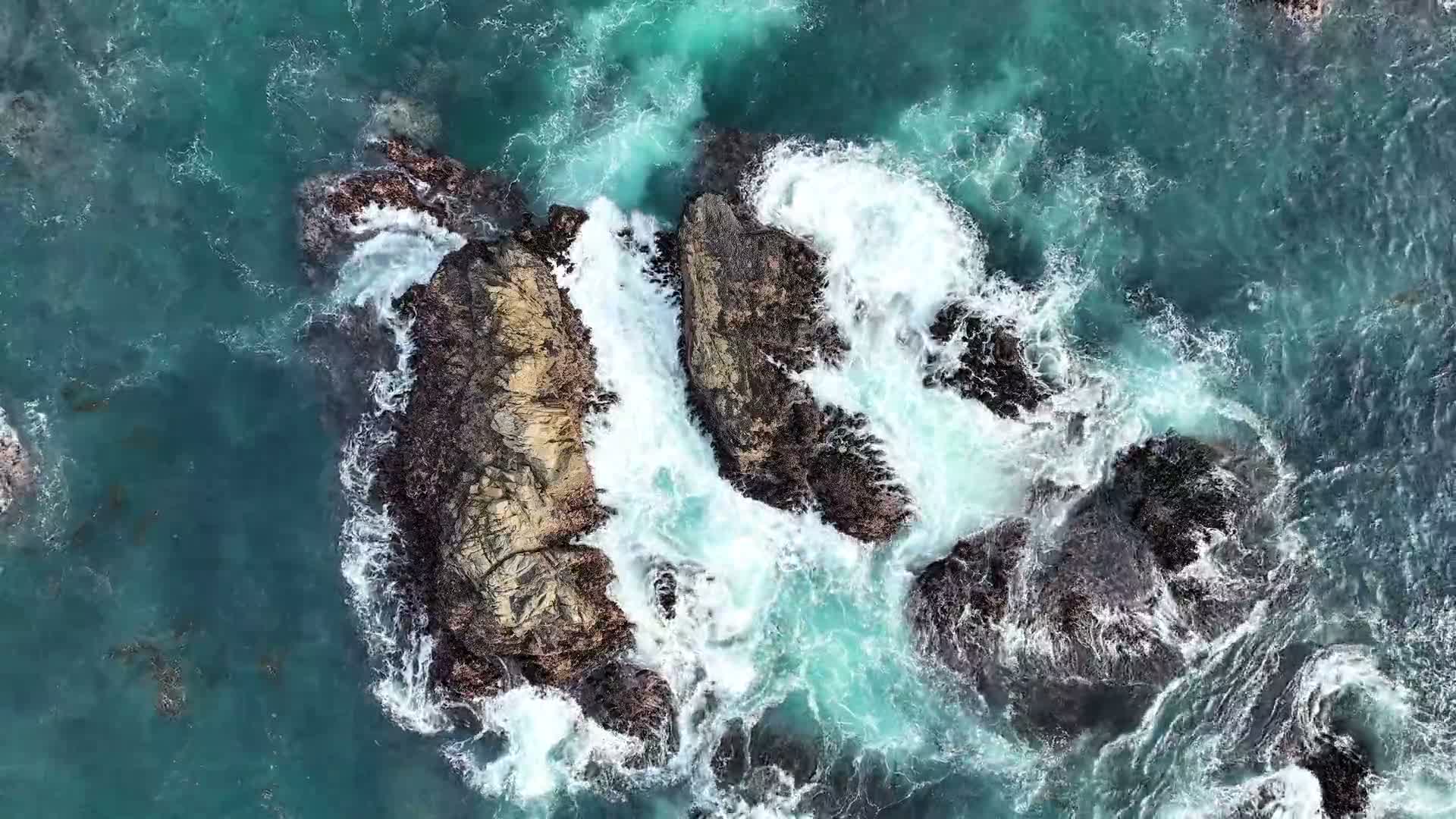 Ocean waves around coastal rocks